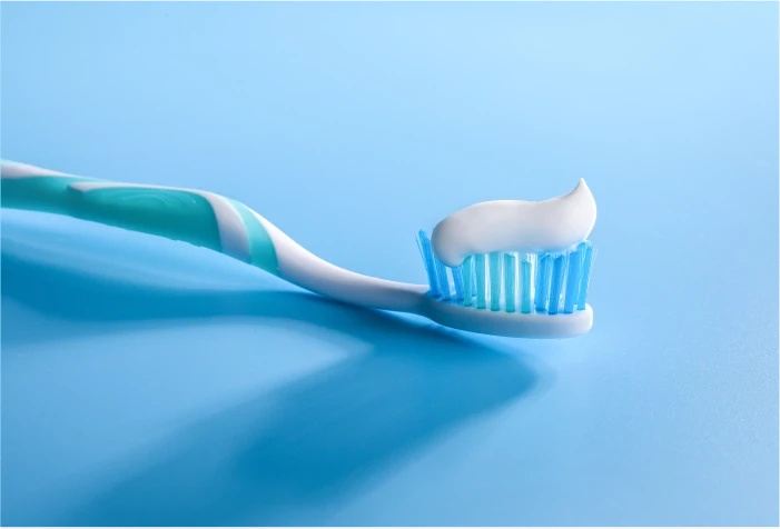 Toothbrush with white toothpaste on it