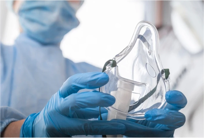 Oxygen mask being used by a health professional